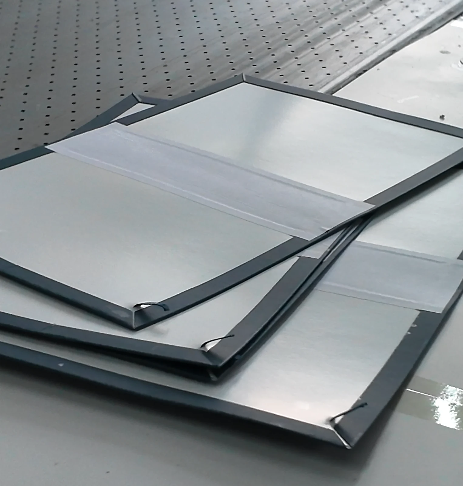 Wrapped case components laid flat on a production table.